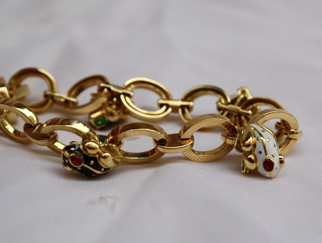 David Webb 18K Yellow Gold Enamel Frog Bracelet with 5 Frogs: David Webb 18K Yellow Gold Enamel Frog Bracelet with 5 Frogs This exquisite David Webb bracelet showcases a charming frog design, meticulously crafted with 18K yellow gold and colorful enamel accents.
