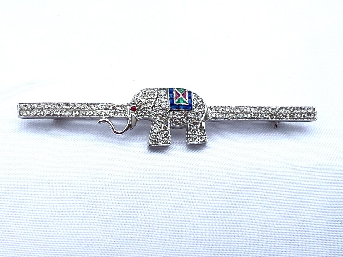 French Art Deco 18K White Gold Elephant Brooch with Diamonds Emeralds Rubies: French Art Deco 18K White Gold Elephant Brooch with Diamonds Emeralds Rubies This stunning French Art Deco brooch features a remarkable design of an elephant crafted in 18K white gold, adorned with ex