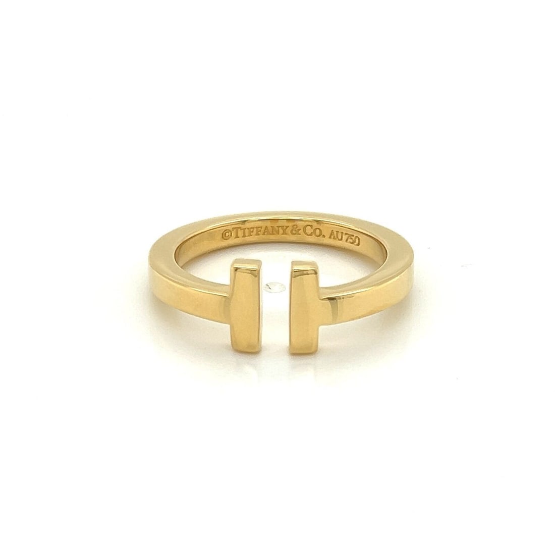 Tiffany T Square 18k Yellow Gold Band Ring Size 8.5: Tiffany T Square 18k Yellow Gold Band Ring Size 8.5 This Tiffany & Co. 2T Square band ring is crafted from 18k yellow gold and features the iconic T Square design. The ring is a size 8.5 with a front