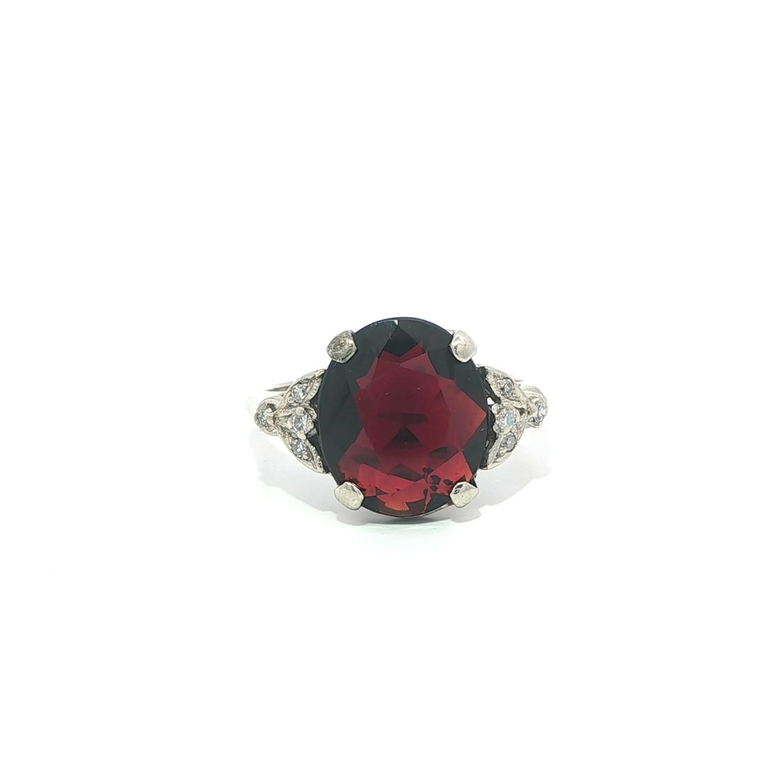 Mid Century 10k White Gold Cocktail Ring With Oval Garnet And Diamonds: Mid Century 10k White Gold Cocktail Ring With Oval Garnet And Diamonds This vintage mid-century cocktail ring features a deep red, oval brilliant cut natural garnet as the centerpiece, set in solid wh