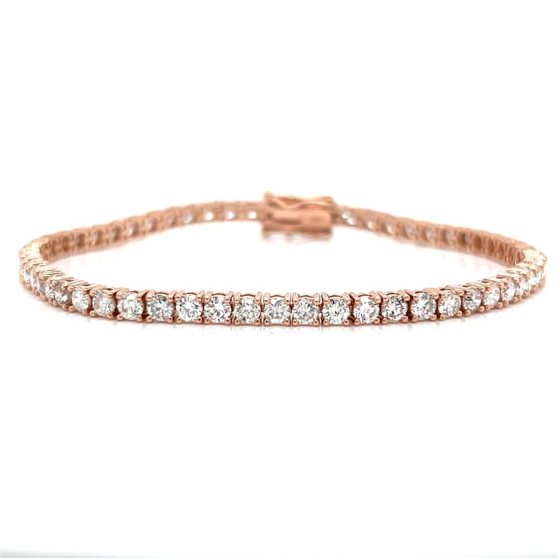 14K Rose Gold Tennis Bracelet 58 Diamonds 5.20 Ct H-I VS1-VS2: 14K Rose Gold Tennis Bracelet 58 Diamonds 5.20 Ct H-I VS1-VS2 This stunning 14K rose gold tennis bracelet features an exquisite arrangement of 58 diamonds, totaling approximately 5.20 carats. The diam
