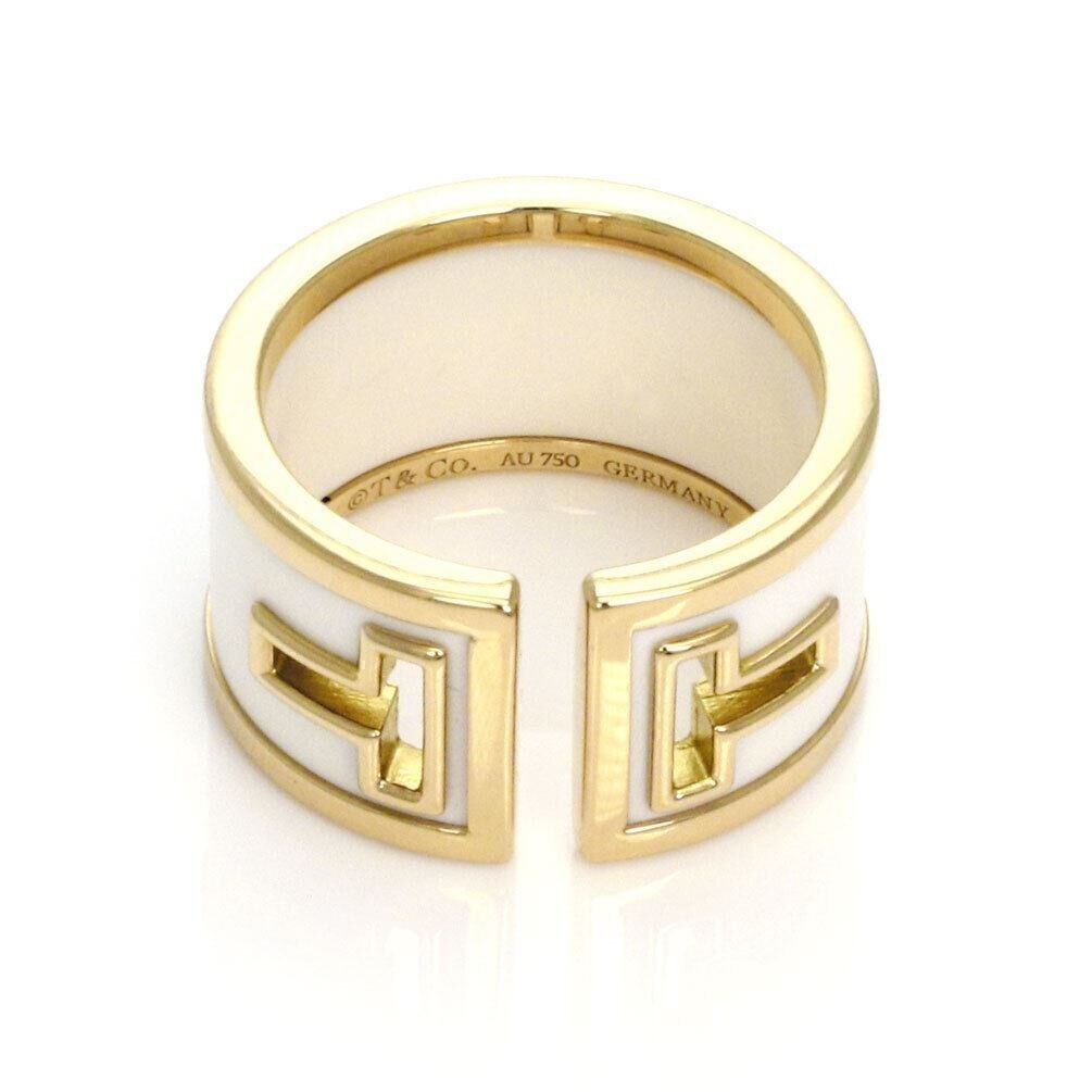 Wide Band T Cut Ring in White Ceramic and 18k Yellow Gold Size 6: Wide Band T Cut Ring in White Ceramic and 18k Yellow Gold Size 6 This Tiffany & Co. T Cut wide band ring features a striking white ceramic center accented by 18k yellow gold. The band showcases the si