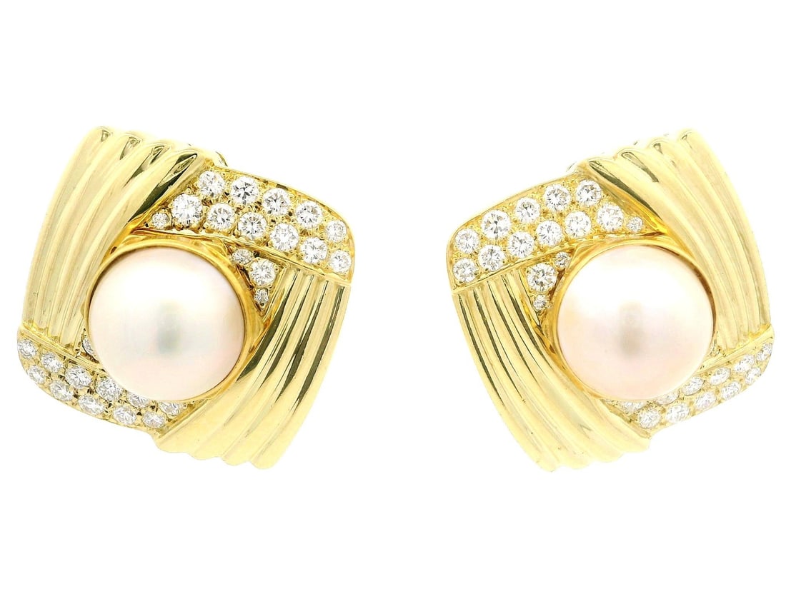 18K Yellow Gold Mabe Pearl and Diamond Button Omega Earrings: 18K Yellow Gold Mabe Pearl and Diamond Button Omega Earrings Elevate your style with these exquisite large button omega earrings, featuring stunning 11.6mm genuine cultured Mabe pearls. Each pearl exh