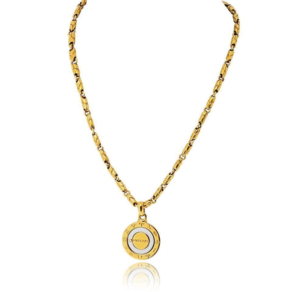 18k Gold and Steel Bvlgari Zodiac Pendant with Diamond and Original Chain: 18k Gold and Steel Bvlgari Zodiac Pendant with Diamond and Original Chain This Bvlgari Zodiac Kingdom pendant features a coin-style design crafted from 18k gold and stainless steel, highlighted by zod