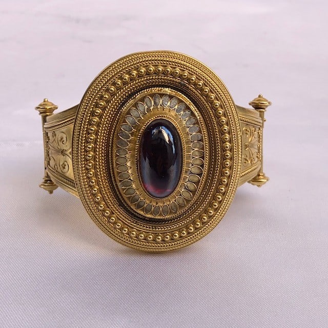 19th Century Victorian 18K Yellow Gold Garnet Enameled Bangle Bracelet: 19th Century Victorian 18K Yellow Gold Garnet Enameled Bangle Bracelet This exquisite Victorian English bracelet from the 19th century showcases a stunning handmade design crafted from 18K yellow gold