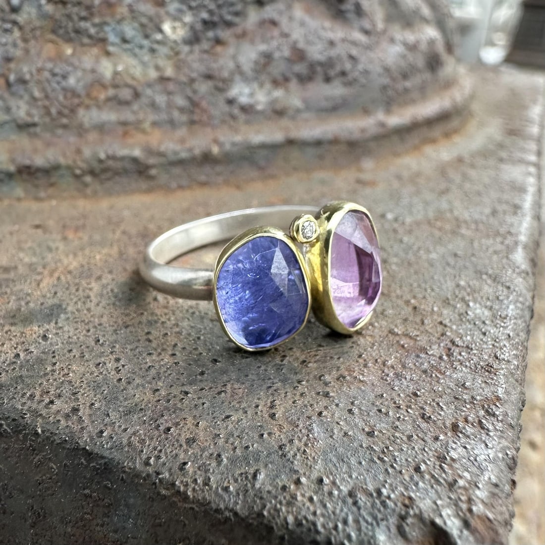 Band Ring in Sterling Silver and 18k Gold with Amethyst Tanzanite and Diamond: Band Ring in Sterling Silver and 18k Gold with Amethyst Tanzanite and Diamond This women's band ring features a natural briolette-cut amethyst and tanzanite, both bezel set, along with a round brillia