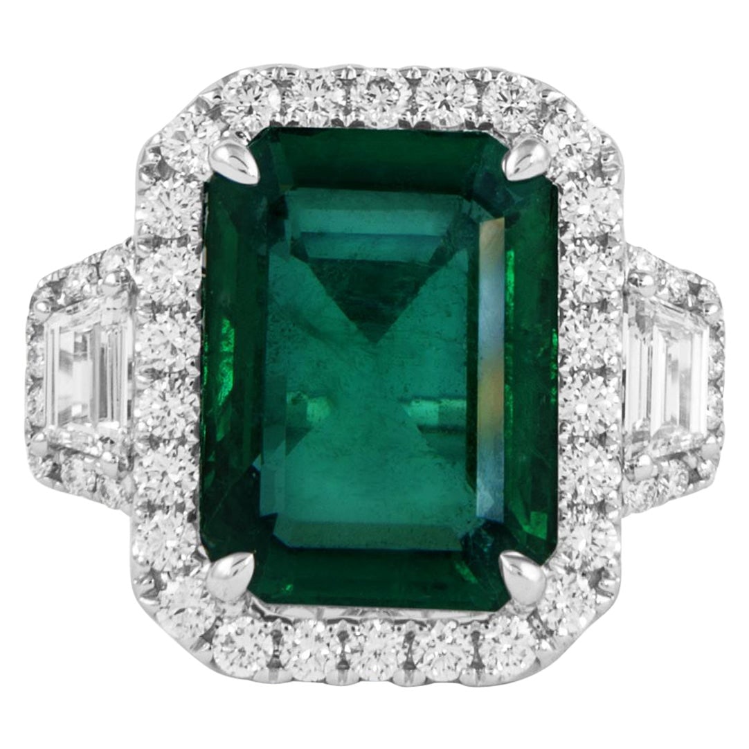 GIA 6.09ct Emerald Diamond 3-Stone Ring 18k White Gold: GIA 6.09ct Emerald Diamond 3-Stone Ring 18k White Gold This exquisite GIA 6.09ct Emerald & Diamond 3-Stone Ring is crafted in 18k white gold and features a stunning vivid green emerald at its center,