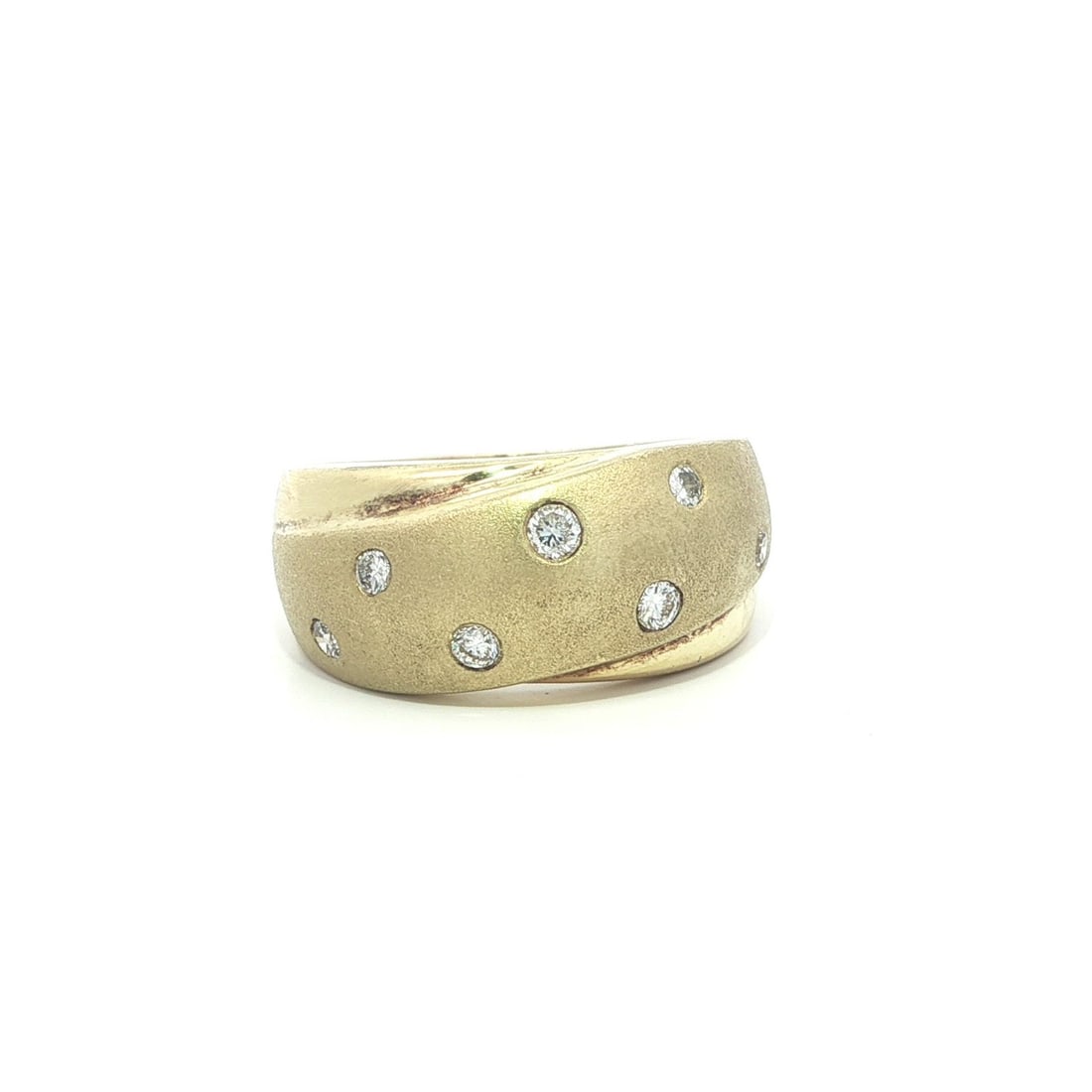 Yellow Gold Band Ring with 0.20ctw Diamonds Sandblast and Polished Finish: Yellow Gold Band Ring with 0.20ctw Diamonds Sandblast and Polished Finish This elegant crossover band ring features a blend of sandblast and polished finishes in solid 14k yellow gold. Set with seven