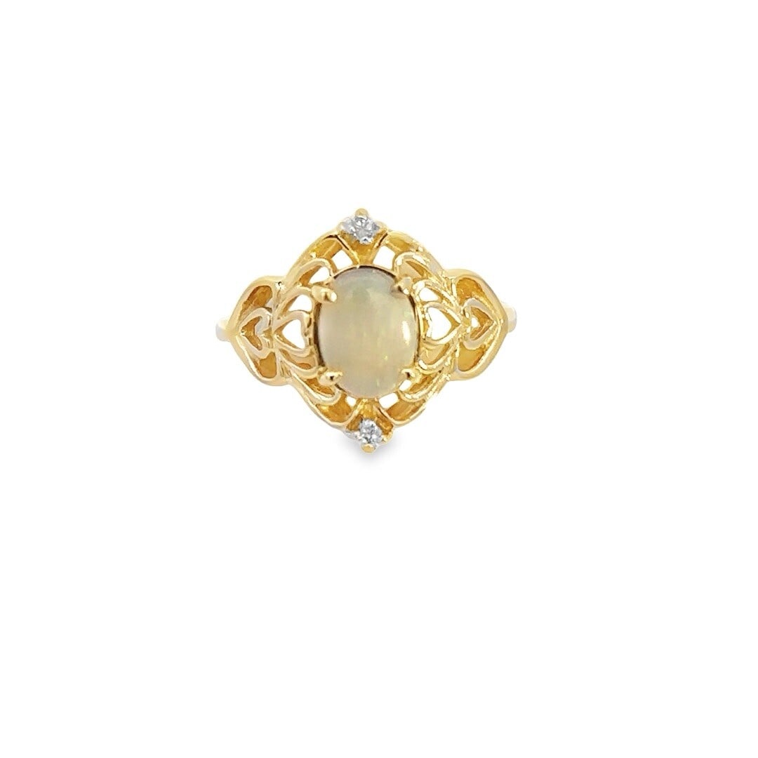 14k Yellow Gold Opal Diamond Heart Design Ring Size 8: 14k Yellow Gold Opal Diamond Heart Design Ring Size 8 This stunning ring features a 14k yellow gold setting adorned with an oval cabochon opal and two round brilliant cut diamonds, making it a perfect