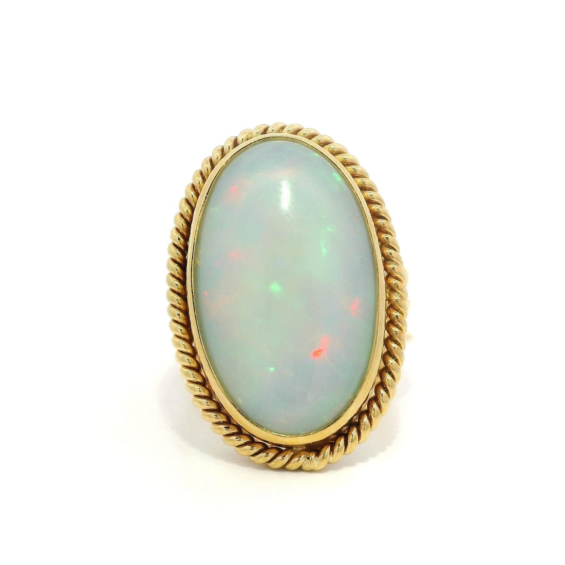 Vintage Handmade 16k Yellow Gold White Opal Cocktail Ring: Vintage Handmade 16k Yellow Gold White Opal Cocktail Ring This exquisite vintage cocktail ring showcases a stunning large white opal, expertly set in a twisted wire bezel. The opal features a captivat