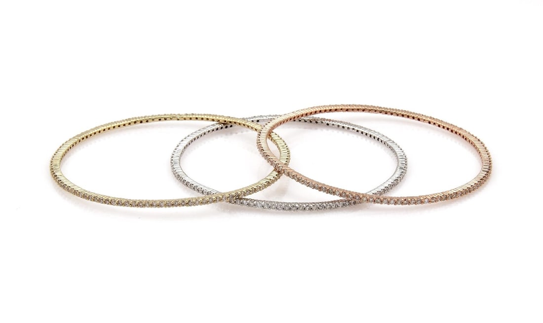 Tricolor 14k Gold 5.25ctw Diamond Bangle Set of 3: Tricolor 14k Gold 5.25ctw Diamond Bangle Set of 3 This exquisite set of three bangles is made from 14k rose, yellow, and white gold. Each bangle features a stunning full circle of round cut prong set