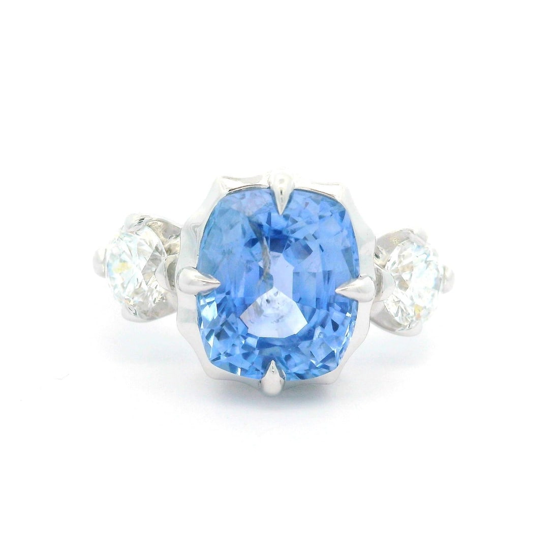 18k White Gold GIA 5.36ct Cushion Blue Sapphire Diamond Ring: 18k White Gold GIA 5.36ct Cushion Blue Sapphire Diamond Ring This stunning 18k white gold ring features a captivating 5.36 carat cushion-cut periwinkle blue sapphire, accompanied by two dazzling round