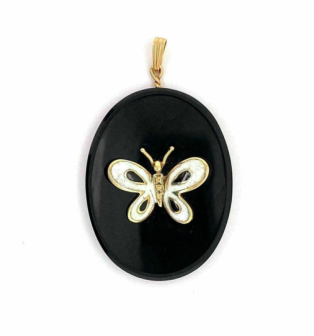 Vintage Oval Butterfly Pendant in Onyx Enamel and 14k Yellow Gold: Vintage Oval Butterfly Pendant in Onyx Enamel and 14k Yellow Gold This vintage oval charm pendant features a butterfly design crafted in 14k yellow gold with onyx enamel accents. The piece is original