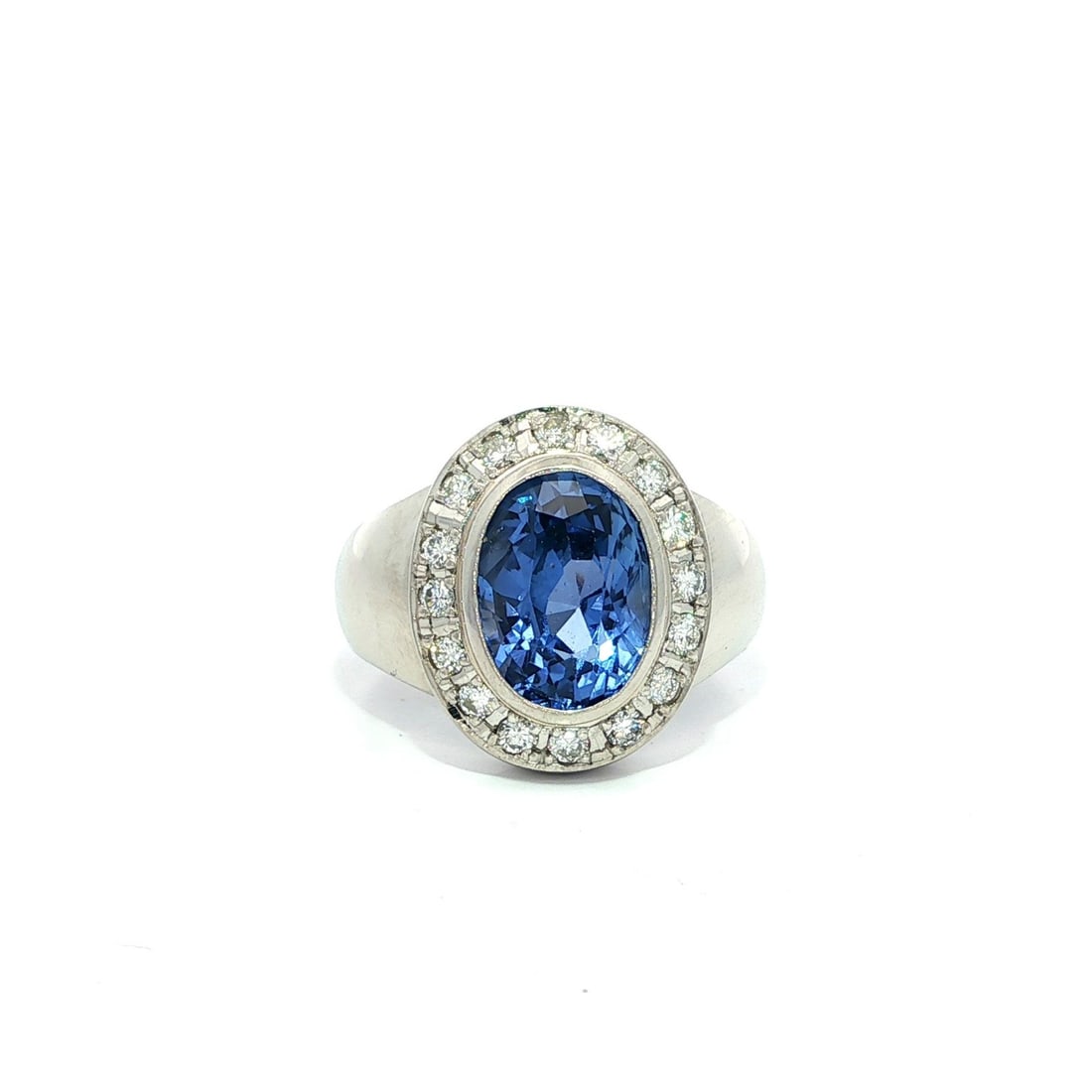 Platinum GIA Certified 4.15ct Ceylon Sapphire Diamond Halo Ring: Platinum GIA Certified 4.15ct Ceylon Sapphire Diamond Halo Ring This exquisite cocktail ring features a stunning natural sapphire from Ceylon, weighing 3.83 carats, skillfully bezel set to enhance its