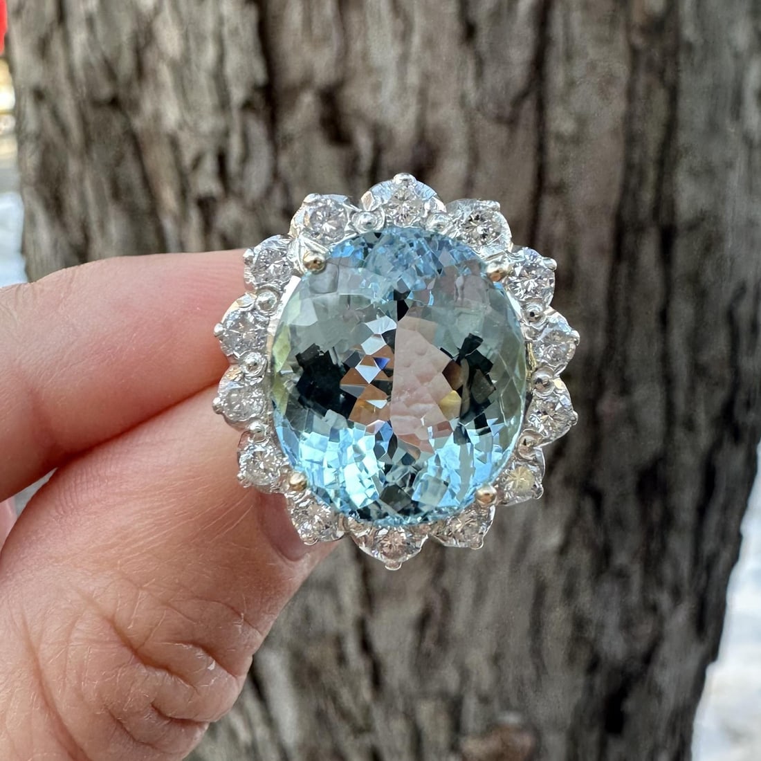 Oval Aquamarine and Diamond Halo Cocktail Ring in Yellow Gold with GIA Certification: Oval Aquamarine and Diamond Halo Cocktail Ring in Yellow Gold with GIA Certification This vintage cocktail ring features a striking natural oval-cut aquamarine, weighing approximately 11.2 carats and