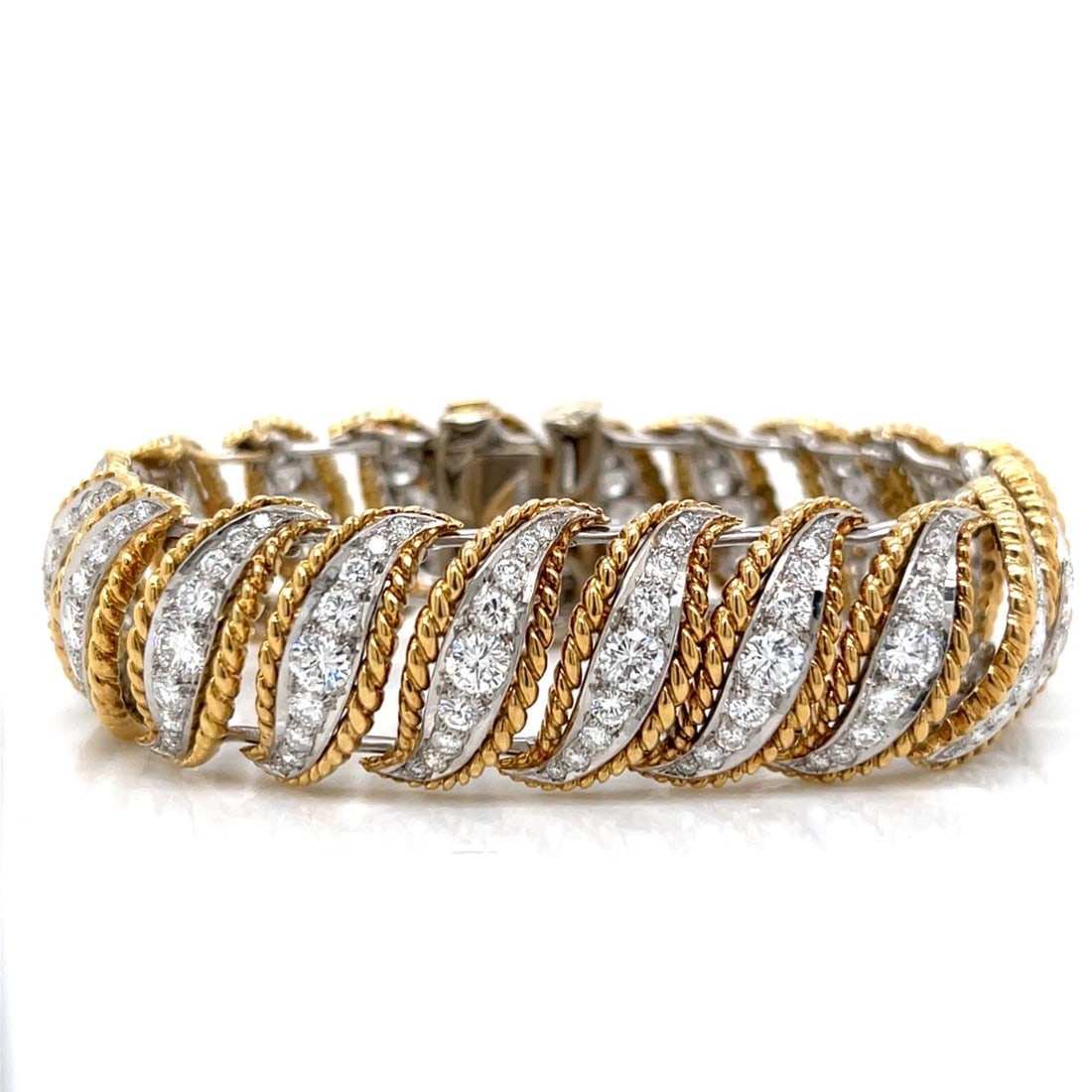 1960s 18K Yellow Gold Platinum Diamond Bracelet 11.20 Ct: 1960s 18K Yellow Gold Platinum Diamond Bracelet 11.20 Ct This exquisite 1960's bracelet showcases a stunning combination of 18K yellow gold and platinum, featuring a breathtaking array of 180 diamonds