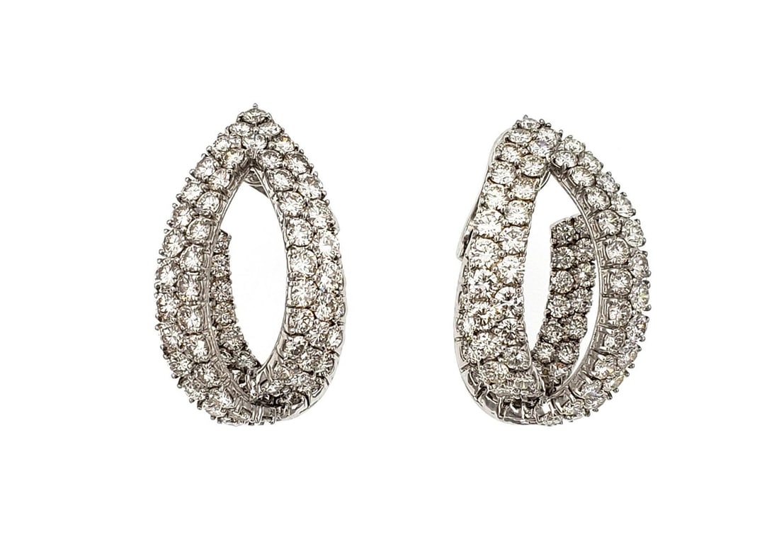 Elegant 18k White Gold Inside Out Diamond Oval Hoop Earrings: Elegant 18k White Gold Inside Out Diamond Oval Hoop Earrings This exquisite pair of estate earrings showcases a stunning design crafted from 18k white gold. The earrings feature a unique open eye shap