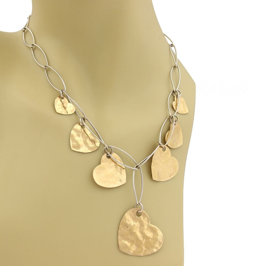 Lariat Necklace in 18k Two Tone Gold with Hammered Dangling Hearts and Oval Links: Lariat Necklace in 18k Two Tone Gold with Hammered Dangling Hearts and Oval Links This lariat necklace showcases a unique design with hammered dangling hearts crafted in graduated sizes. Made from 18k