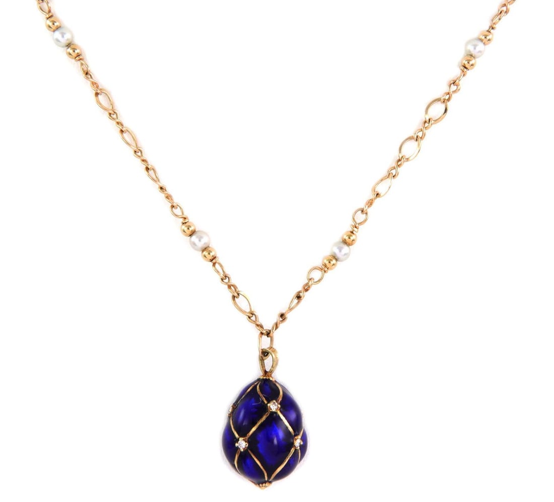 Elegant 14k Yellow Gold Enamel Egg Pendant with Diamonds and Pearls: Elegant 14k Yellow Gold Enamel Egg Pendant with Diamonds and Pearls This exquisite pendant and chain set is crafted from 14k yellow gold. The pendant showcases a stunning cobalt blue enamel egg, elega