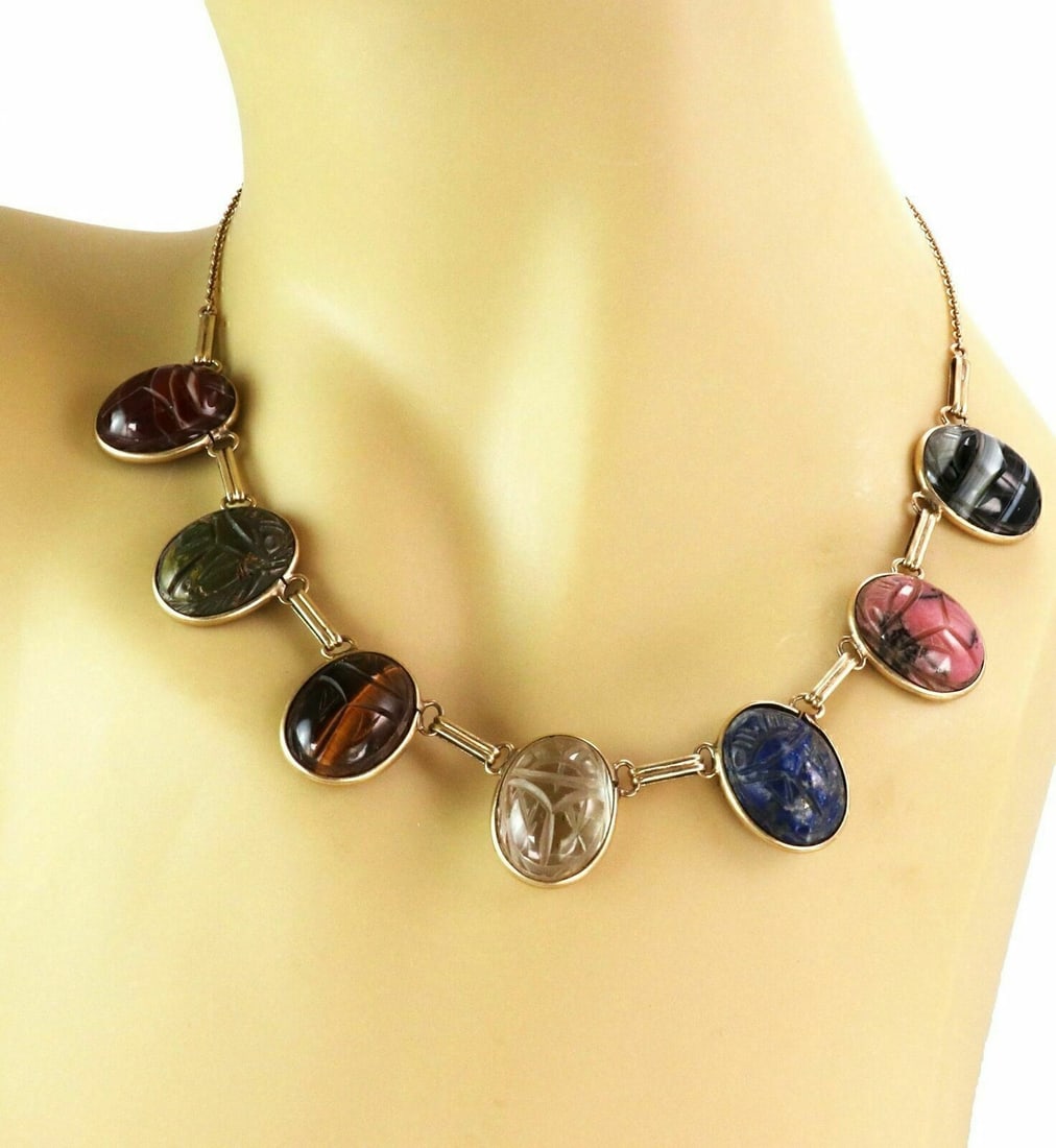 Vintage 14k Yellow Gold Necklace With Multicolor Carved Gemstone Scarabs: Vintage 14k Yellow Gold Necklace With Multicolor Carved Gemstone Scarabs This vintage choker necklace features multicolor carved gemstones set in 14k yellow gold. The design includes an oval scarab mo