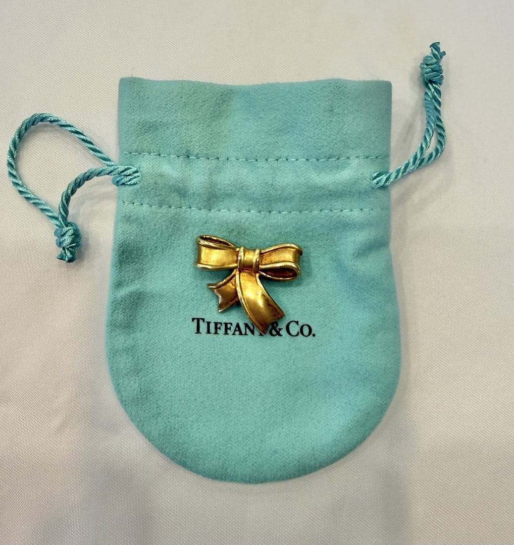 1985 Angela Cummings Bow Brooch in 18k Yellow Gold: 1985 Angela Cummings Bow Brooch in 18k Yellow Gold This 1985 Tiffany & Co. brooch, designed by Angela Cummings, is crafted from 18k yellow gold in an elegant bow motif. The piece showcases exquisite d