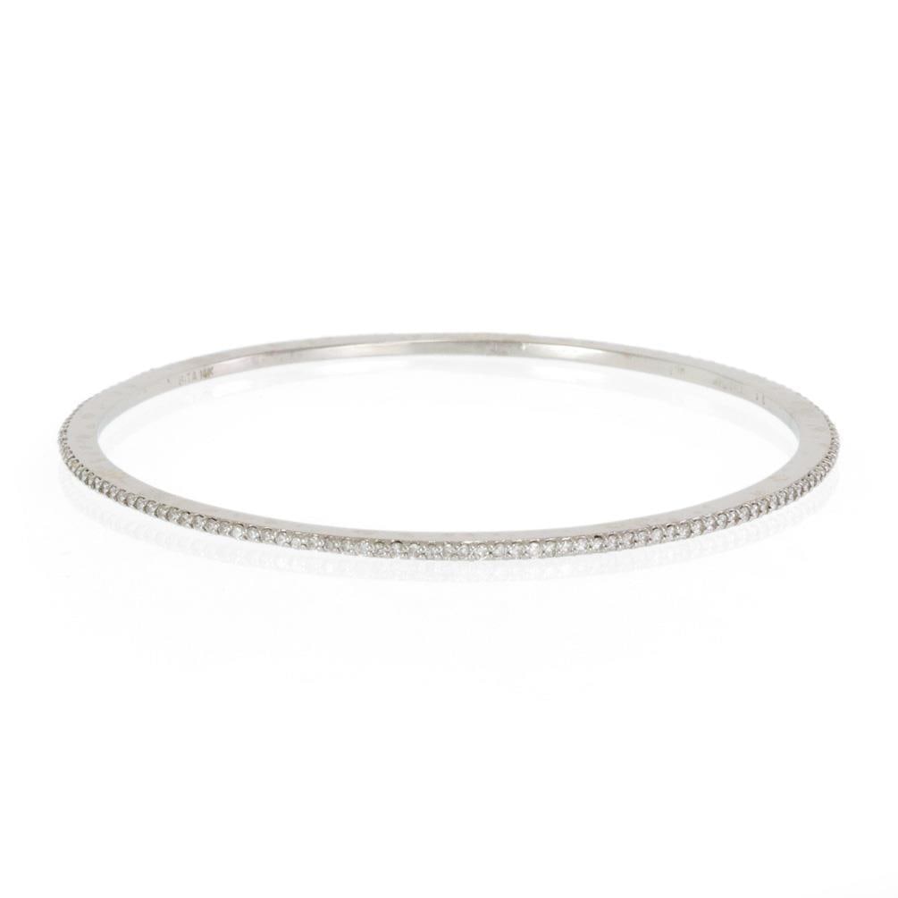 1.5ct Diamond Micropave 14k White Gold Slim Bangle: 1.5ct Diamond Micropave 14k White Gold Slim Bangle This elegant slim bangle is expertly crafted from 14k white gold and features a full circle of micropave set diamonds, totaling 1.50 carats. The diam