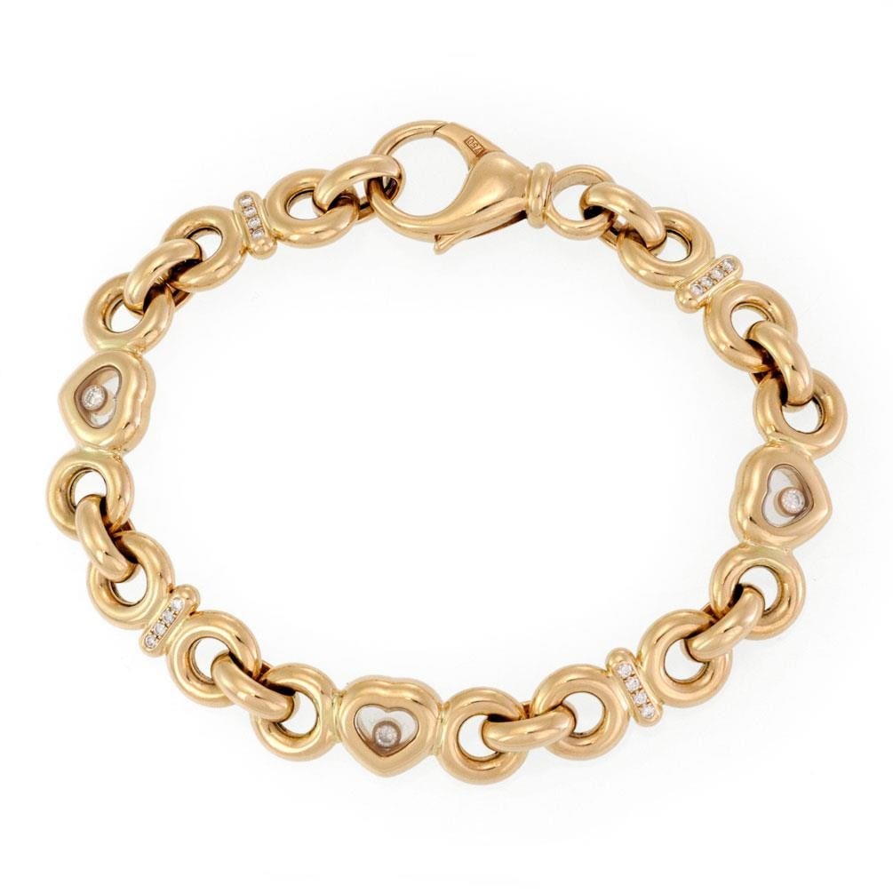 Chopard Happy Diamond 18k Yellow Gold Heart Bracelet with Floating Diamond: Chopard Happy Diamond 18k Yellow Gold Heart Bracelet with Floating Diamond This exquisite bracelet from Chopard's Happy Diamond Collection is crafted from luxurious 18k yellow gold. The design feature