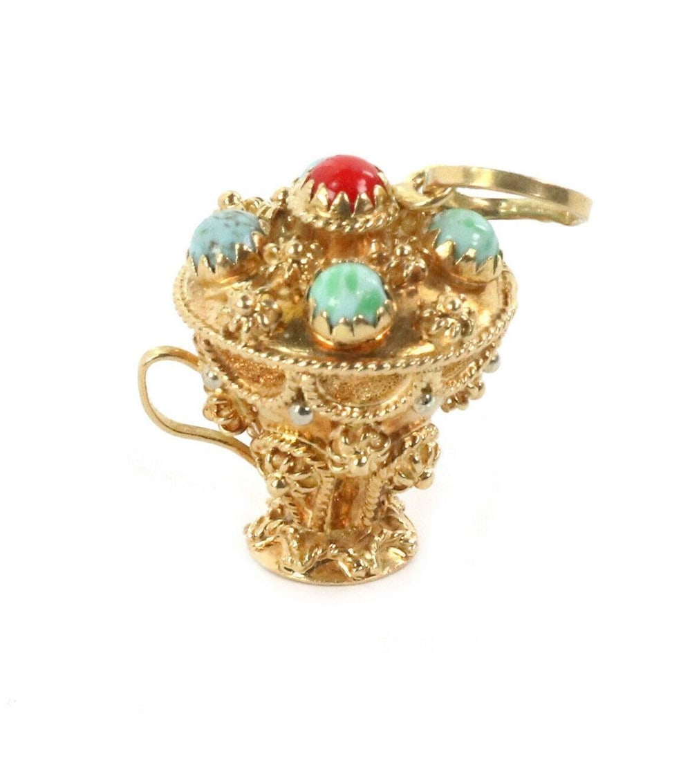 Etruscan Style 18k Gold Pendant with Turquoise and Coral Champion Cup Motif: Etruscan Style 18k Gold Pendant with Turquoise and Coral Champion Cup Motif This vintage pendant features a champion cup charm crafted in 18k yellow gold with an intricate Etruscan design. Accented wi