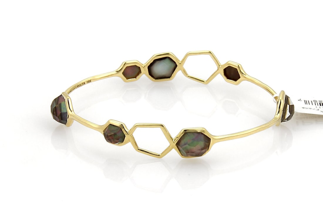 Seven Black Shell Gemstone Bangle in 18k Yellow Gold by Ippolita Rock Candy: Seven Black Shell Gemstone Bangle in 18k Yellow Gold by Ippolita Rock Candy This Ippolita Rock Candy bangle features seven multi-colored black shell stones set in 18k yellow gold. The bracelet has an