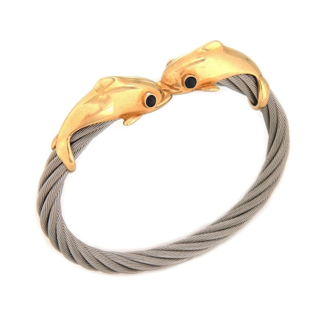 Double Dolphin Sapphire Bangle in 14k Gold and Steel by Steven Douglas: Double Dolphin Sapphire Bangle in 14k Gold and Steel by Steven Douglas This Steven Douglas cuff bangle bracelet features an elegant double dolphin motif crafted in 14k yellow gold and stainless steel.