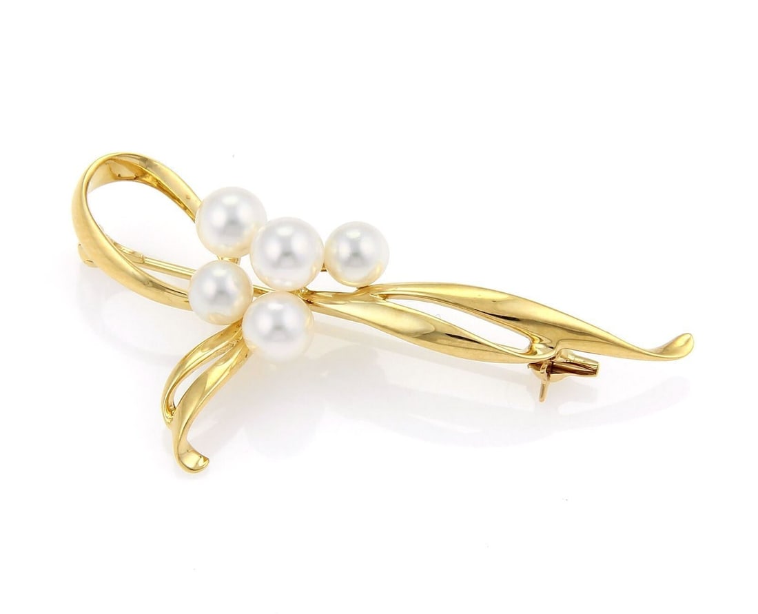 5 Akoya Pearls Ribbon Design 18k Yellow Gold Brooch by Mikimoto: 5 Akoya Pearls Ribbon Design 18k Yellow Gold Brooch by Mikimoto This Mikimoto brooch features five Akoya pearls, each approximately 4-5 mm in diameter, elegantly arranged in a ribbon loop design set i