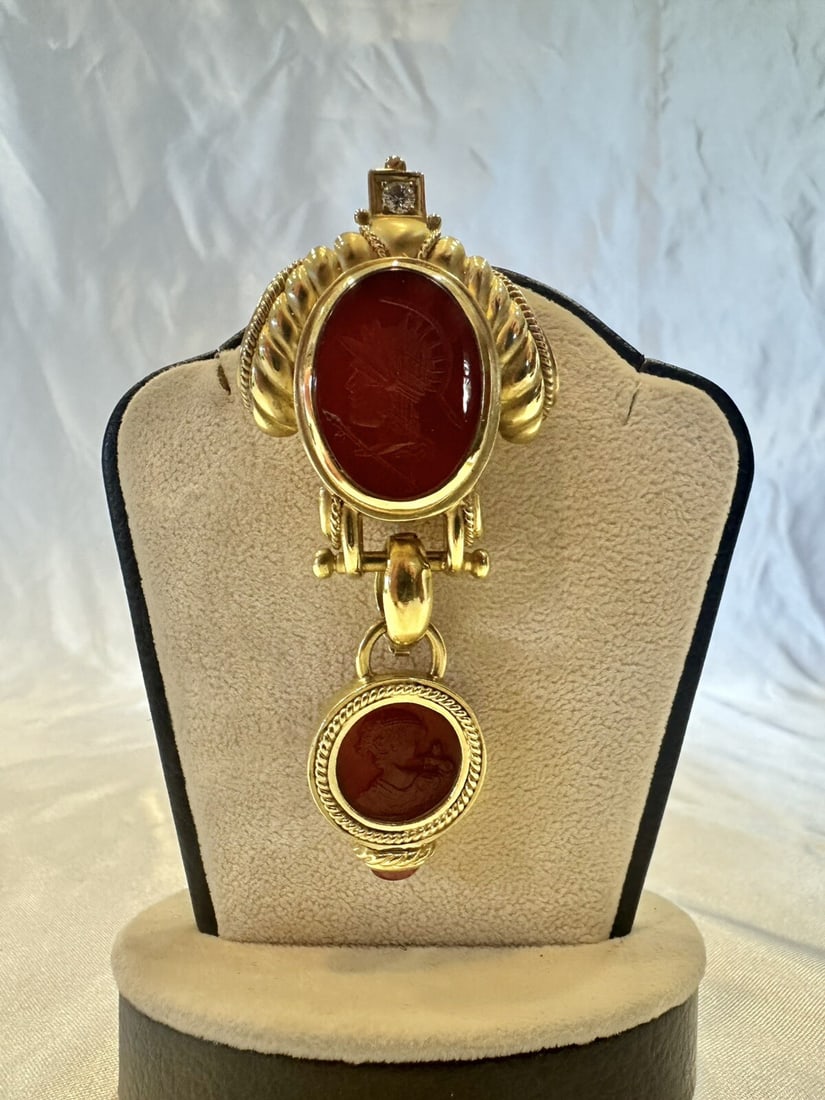 JBL 18K Gold Diamond Tourmaline Carnelian Brooch Pendant: JBL 18K Gold Diamond Tourmaline Carnelian Brooch Pendant This exquisite JBL pendant brooch showcases a stunning combination of 18k yellow gold, diamond tourmaline, and carnelian. The brooch features a