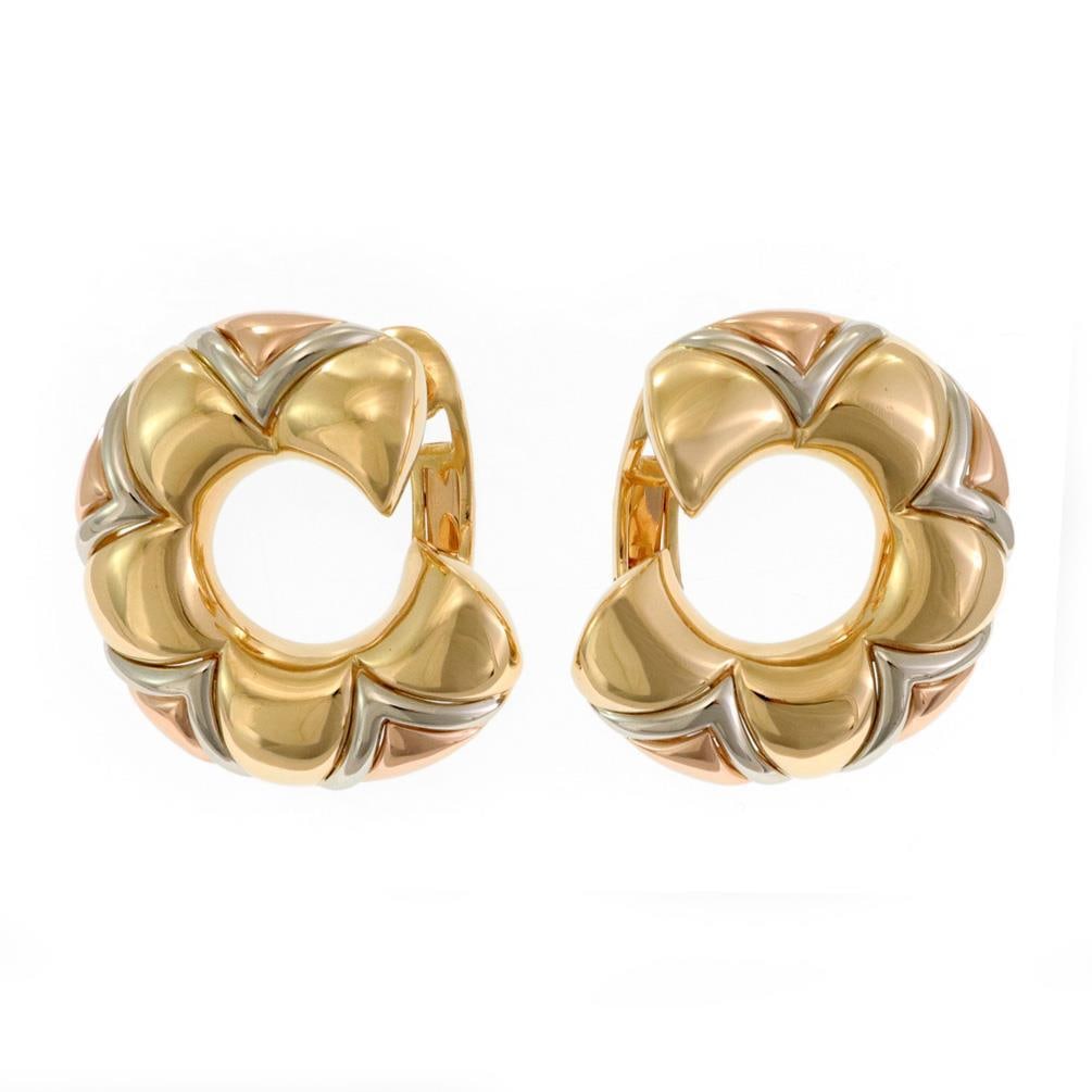 Bvlgari Huggie Earrings in 18k Yellow White Rose Gold V Motif: Bvlgari Huggie Earrings in 18k Yellow White Rose Gold V Motif This authentic pair of Bvlgari huggie earrings is crafted from 18k yellow, rose, and white gold with a polished finish. Featuring a 10mm w