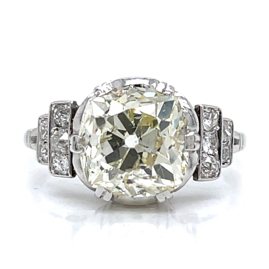 Art Deco Platinum Ring 3.96 Ct Old Cushion Diamond: Art Deco Platinum Ring 3.96 Ct Old Cushion Diamond This stunning Art Deco ring showcases a magnificent 3.96 Ct. Old Cushion-cut diamond, characterized by its M color and SI3 clarity. The ring is craft