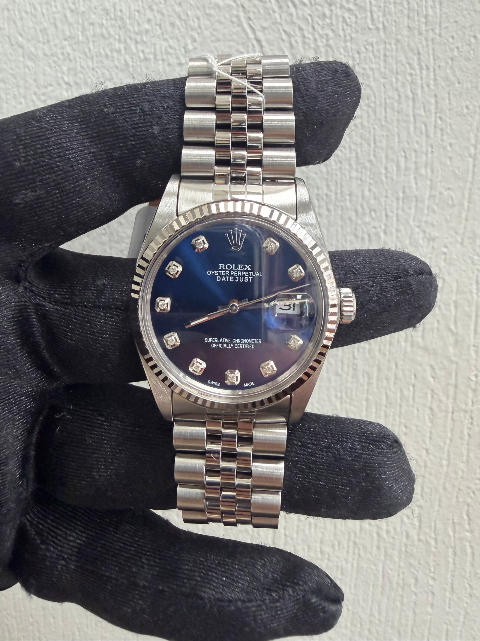 Datejust Ref 16014 Silver Tapestry Dial Watch with Jubilee Bracelet: Datejust Ref 16014 Silver Tapestry Dial Watch with Jubilee Bracelet This Rolex Datejust features a silver tapestry dial and a Jubilee bracelet. It is equipped with a fluted bezel and is identified by