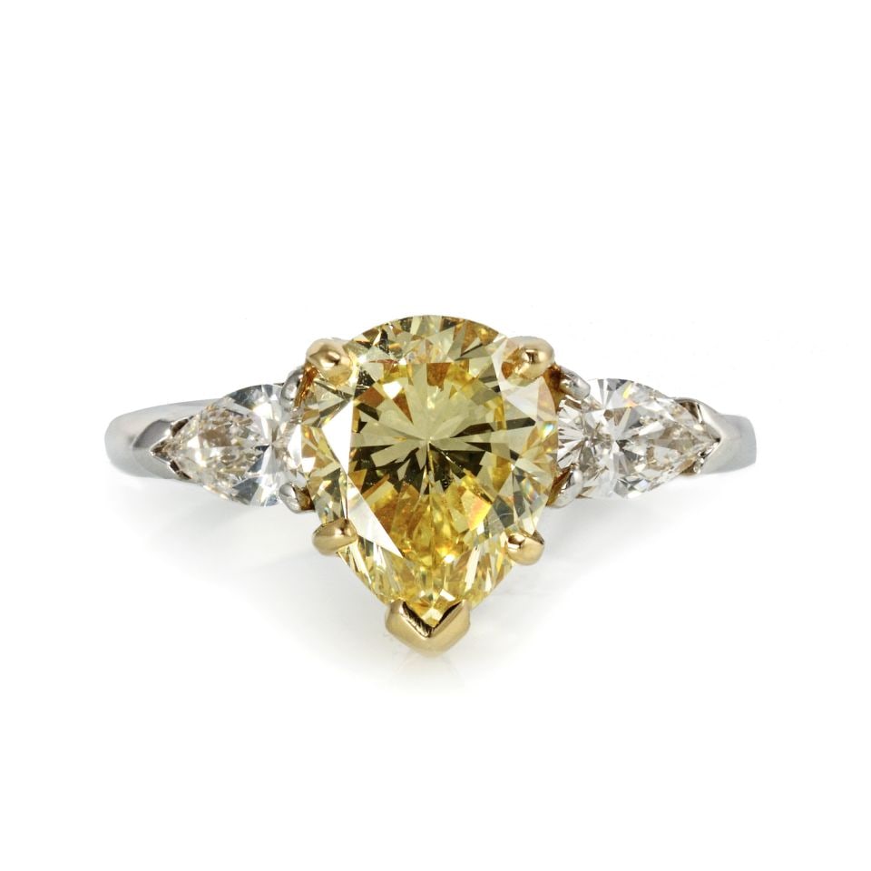 GIA Certified 2.5 Carat Fancy Intense Yellow Three Stone Ring: GIA Certified 2.5 Carat Fancy Intense Yellow Three Stone Ring This exquisite three-stone ring features a stunning 2.5 carat pear-shaped natural fancy intense yellow diamond at its center, flanked by t