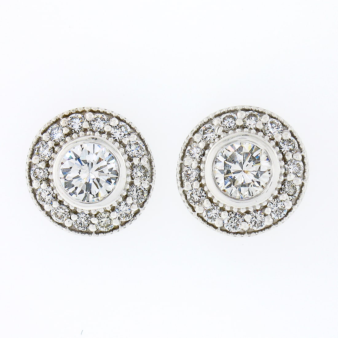 14k White Gold 0.83ctw Diamond Halo Stud Earrings VS1/VS2 Clarity: 14k White Gold 0.83ctw Diamond Halo Stud Earrings VS1/VS2 Clarity Adorn your ears with these exquisite stud earrings crafted in solid 14k white gold. Each earring features a stunning round brilliant d
