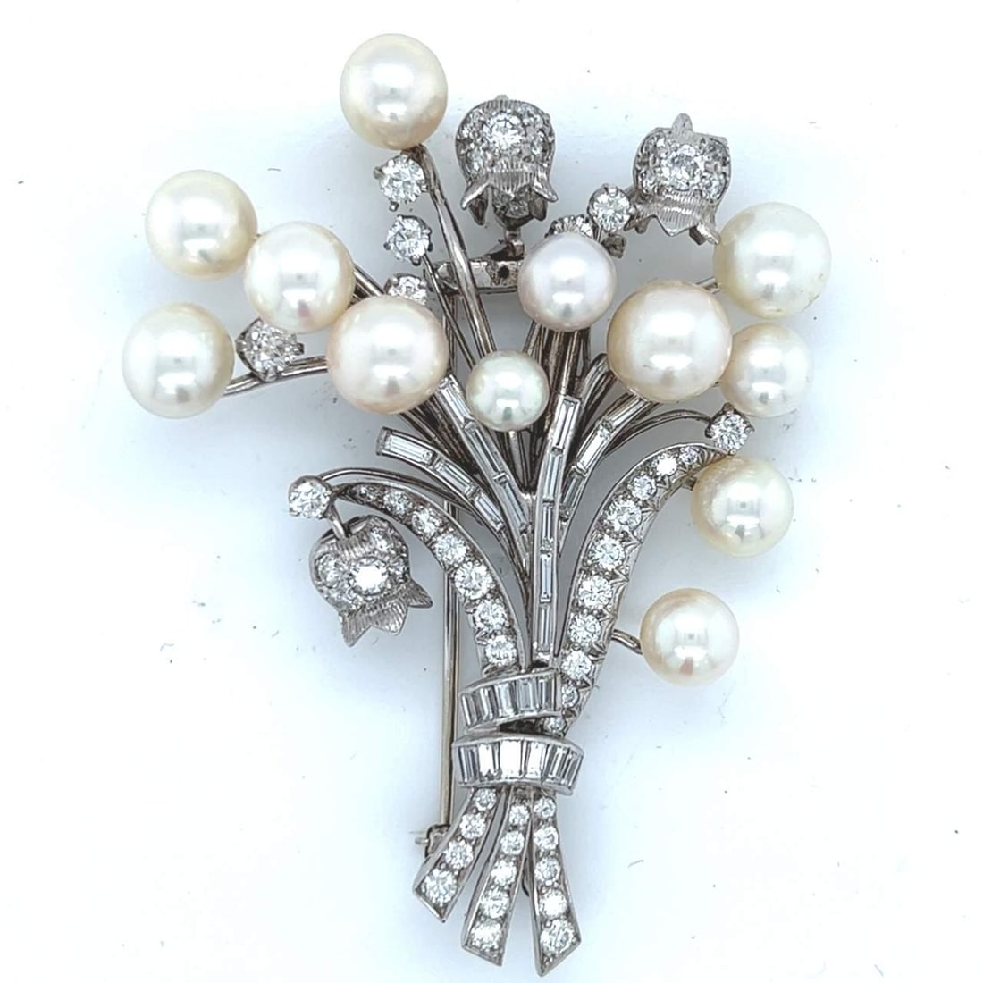 Platinum Flower Bouquet Brooch with 79 Diamonds and Pearls: Platinum Flower Bouquet Brooch with 79 Diamonds and Pearls Discover the elegance of this exquisite Platinum Pearl & Diamond Flower Bouquet Brooch. Weighing 31.1 grams, this stunning piece features 79