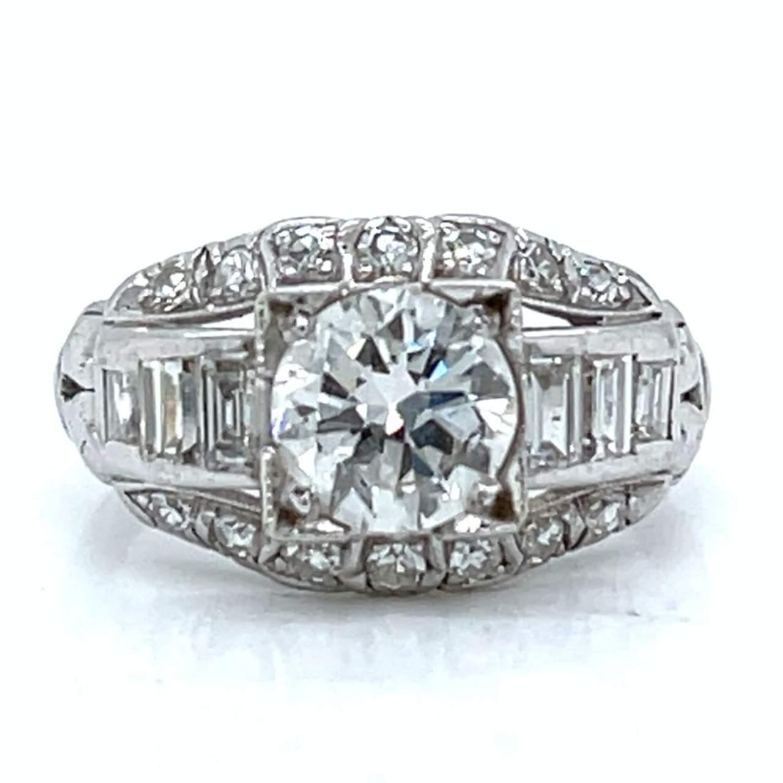 Art Deco Platinum Diamond Ring 1.95 Ct H SI1 F-G VS1-SI1: Art Deco Platinum Diamond Ring 1.95 Ct H SI1 F-G VS1-SI1 This exquisite Art Deco ring is crafted in platinum, showcasing a stunning 1.95 Ct. total diamond weight. The centerpiece features an approxima