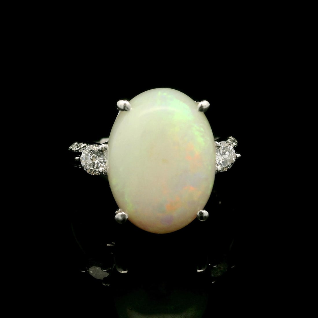 Stunning 6.4ctw Oval Cabochon Opal Diamond Ring in Platinum: Stunning 6.4ctw Oval Cabochon Opal Diamond Ring in Platinum This stunning cocktail ring features a substantial oval cabochon opal, measuring 14.6 x 11.1 mm and weighing 6.05 ct, showcasing a beautiful