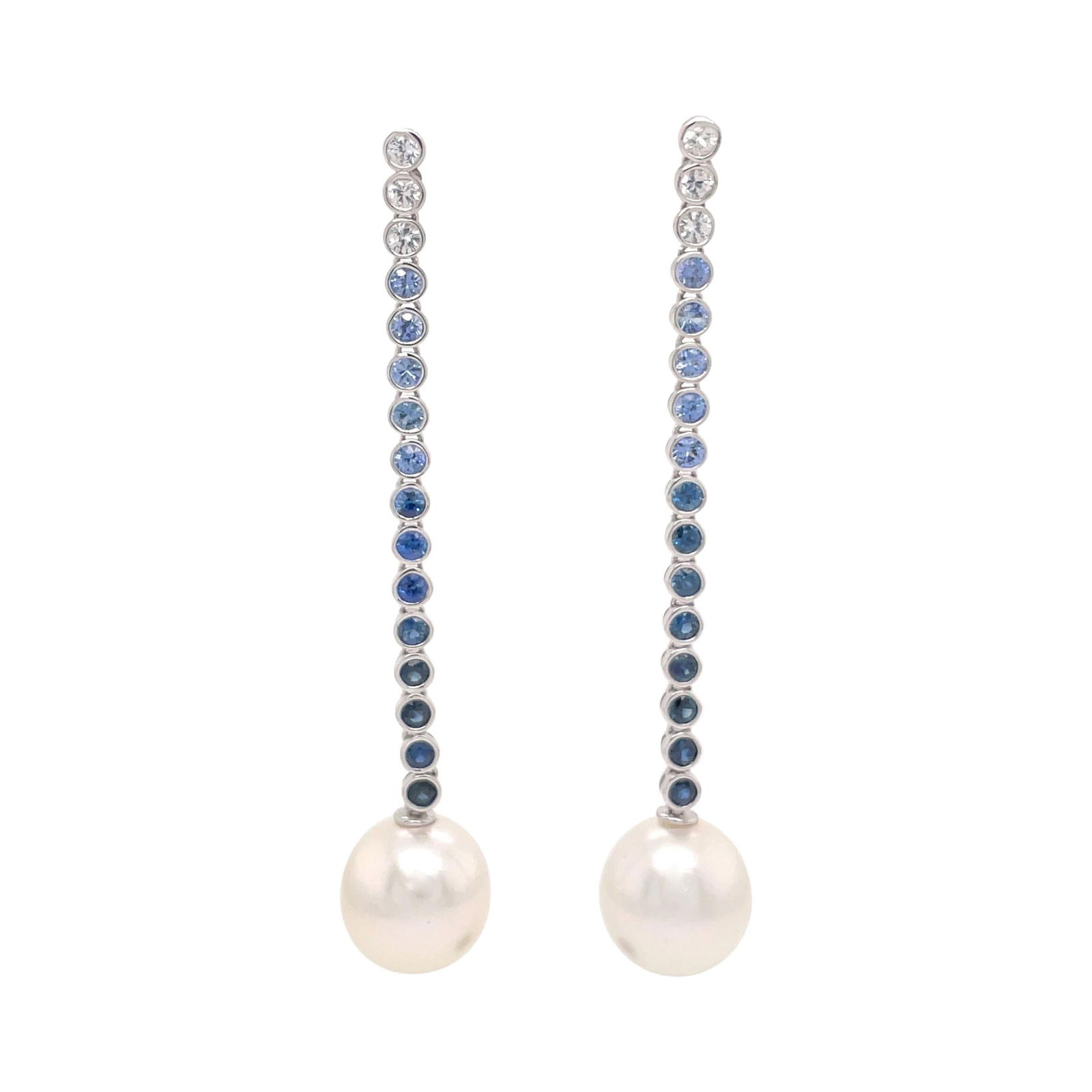Contemporary White Gold Drop Earrings with Ombree Sapphires and South Sea Pearls: Contemporary White Gold Drop Earrings with Ombree Sapphires and South Sea Pearls Elevate your elegance with these stunning 18 Karat White Gold Sapphire Ombree Pearl Drop Earrings. Crafted from high-qu