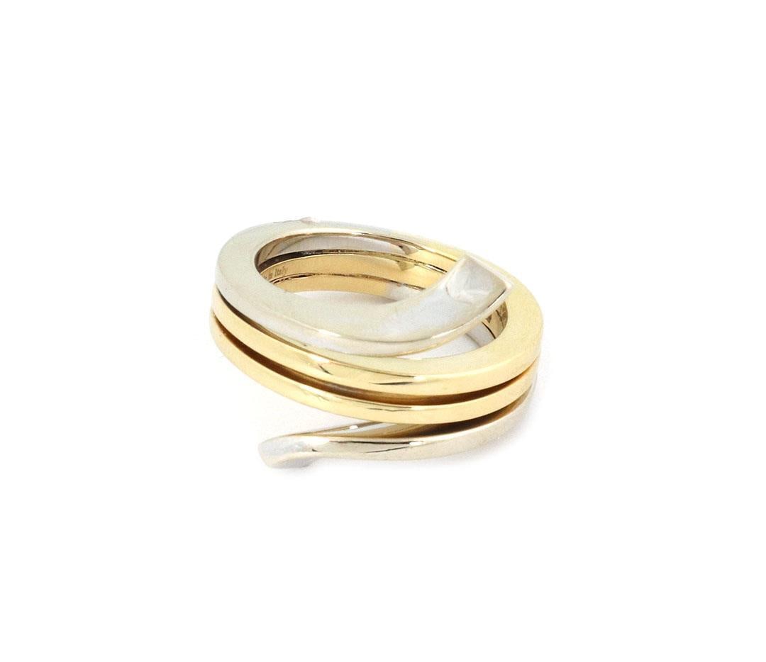 Damiani 18k Gold Bypass Band Ring 4 Rows Polished: Damiani 18k Gold Bypass Band Ring 4 Rows Polished This exquisite ring by Damiani showcases a sophisticated bypass design crafted from 18k white and yellow gold. The ring features four elegantly stacke