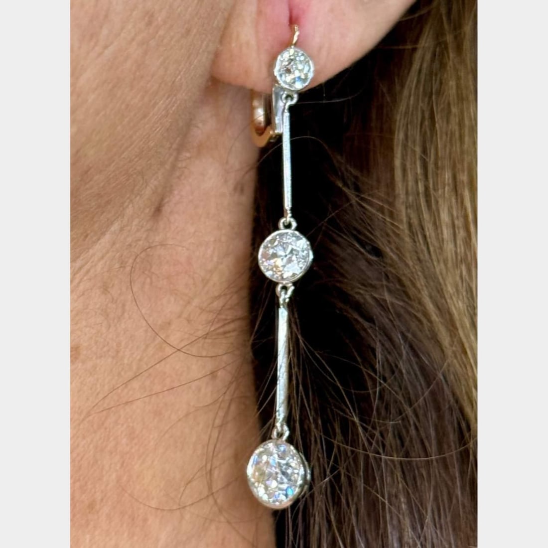 Platinum and 18K 4.89 Ct Diamond Earrings H-I VS1-SI3: Platinum and 18K 4.89 Ct Diamond Earrings H-I VS1-SI3 Exquisite Platinum and 18K Diamond Earrings featuring a total diamond weight of 4.89 Ct. These stunning earrings are set with two diamonds weighin