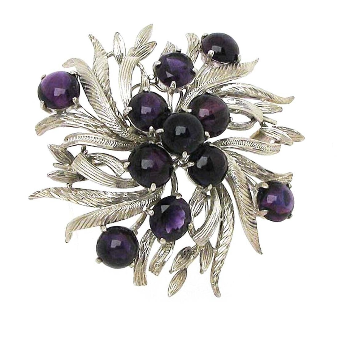 Vintage 14k White Gold Floral Brooch With Cabochon and Faceted Amethysts: Vintage 14k White Gold Floral Brooch With Cabochon and Faceted Amethysts This vintage floral brooch is crafted from solid 14k white gold and features a graceful flower and leaf motif adorned with a co