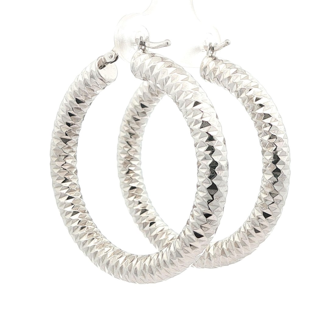 Elegant 14k White Gold 40mm Diamond Cut Hoop Earrings: Elegant 14k White Gold 40mm Diamond Cut Hoop Earrings These stunning Solid 14k White Gold 40mm Faceted Diamond Cut Tube Hoop Earrings are a perfect addition to any jewelry collection. Crafted from sol