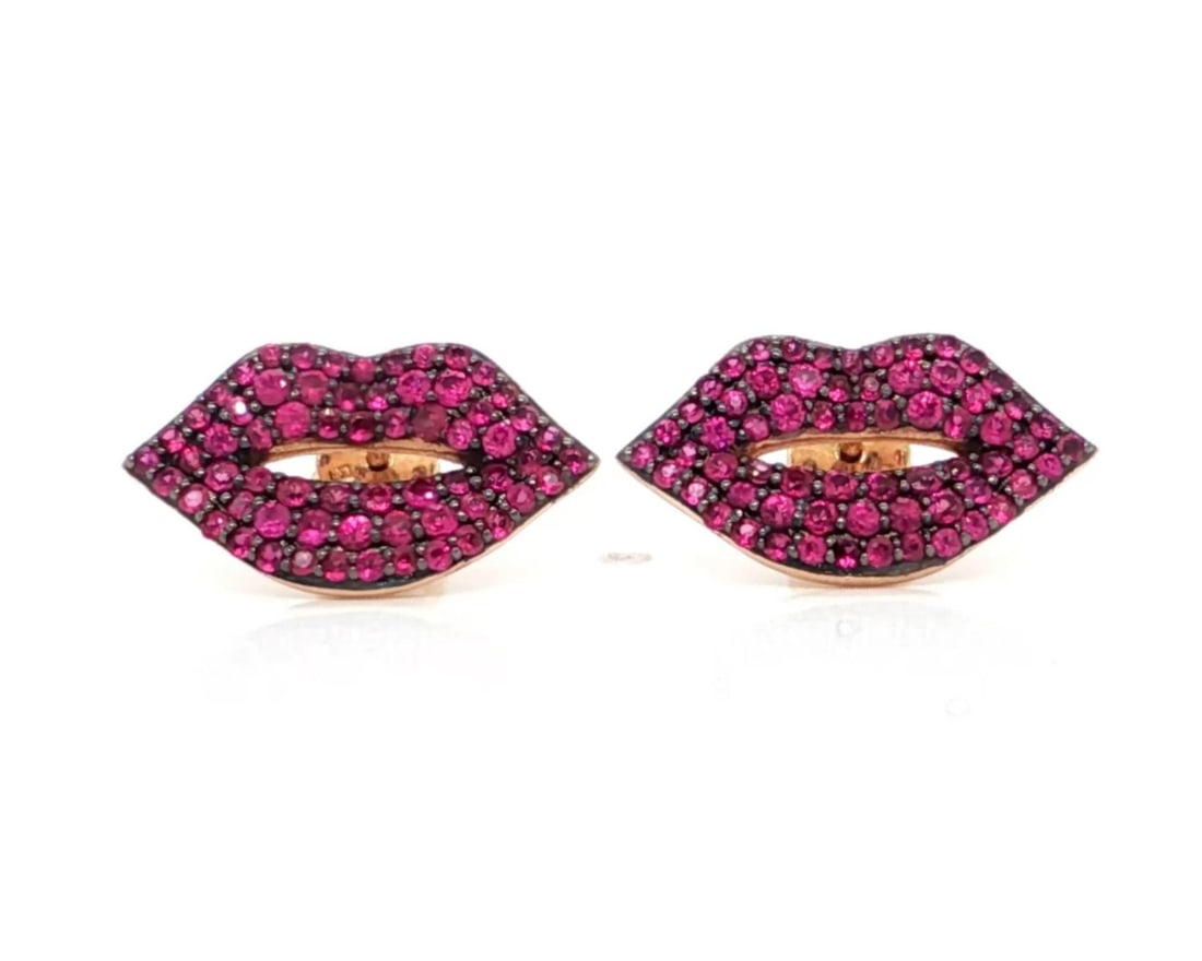 14k Rose Gold Sydney Evan Ruby Lips Stud Earrings: 14k Rose Gold Sydney Evan Ruby Lips Stud Earrings These Sydney Evan Lips stud earrings are crafted from 14k rose gold and feature a playful lips motif adorned with vibrant natural rubies. The design c