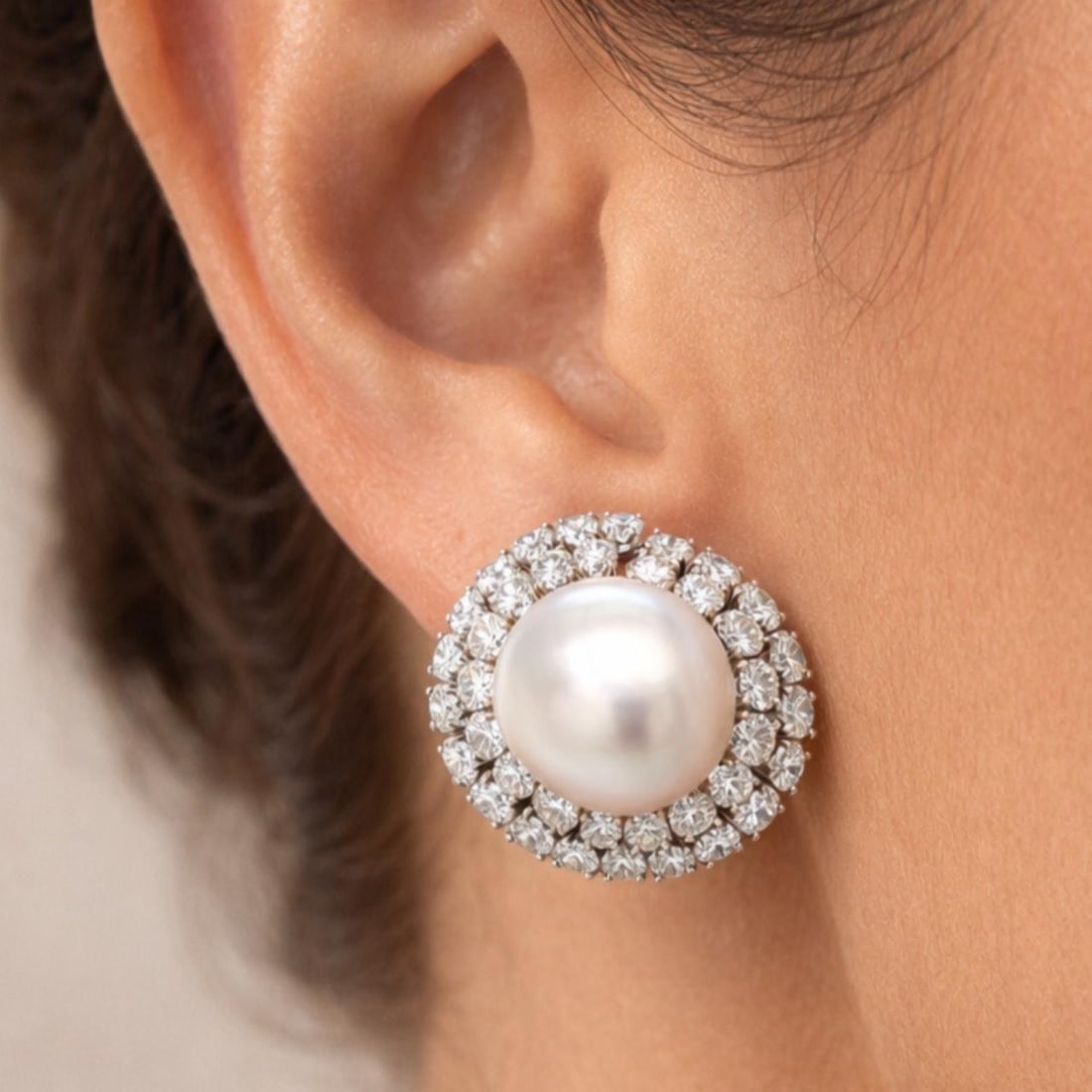 South Sea Pearl and Diamond Platinum Earrings by David Webb: South Sea Pearl and Diamond Platinum Earrings by David Webb These elegant earrings by David Webb are crafted in platinum and feature two South Sea pearls measuring 17.75mm each. The earrings are adorn