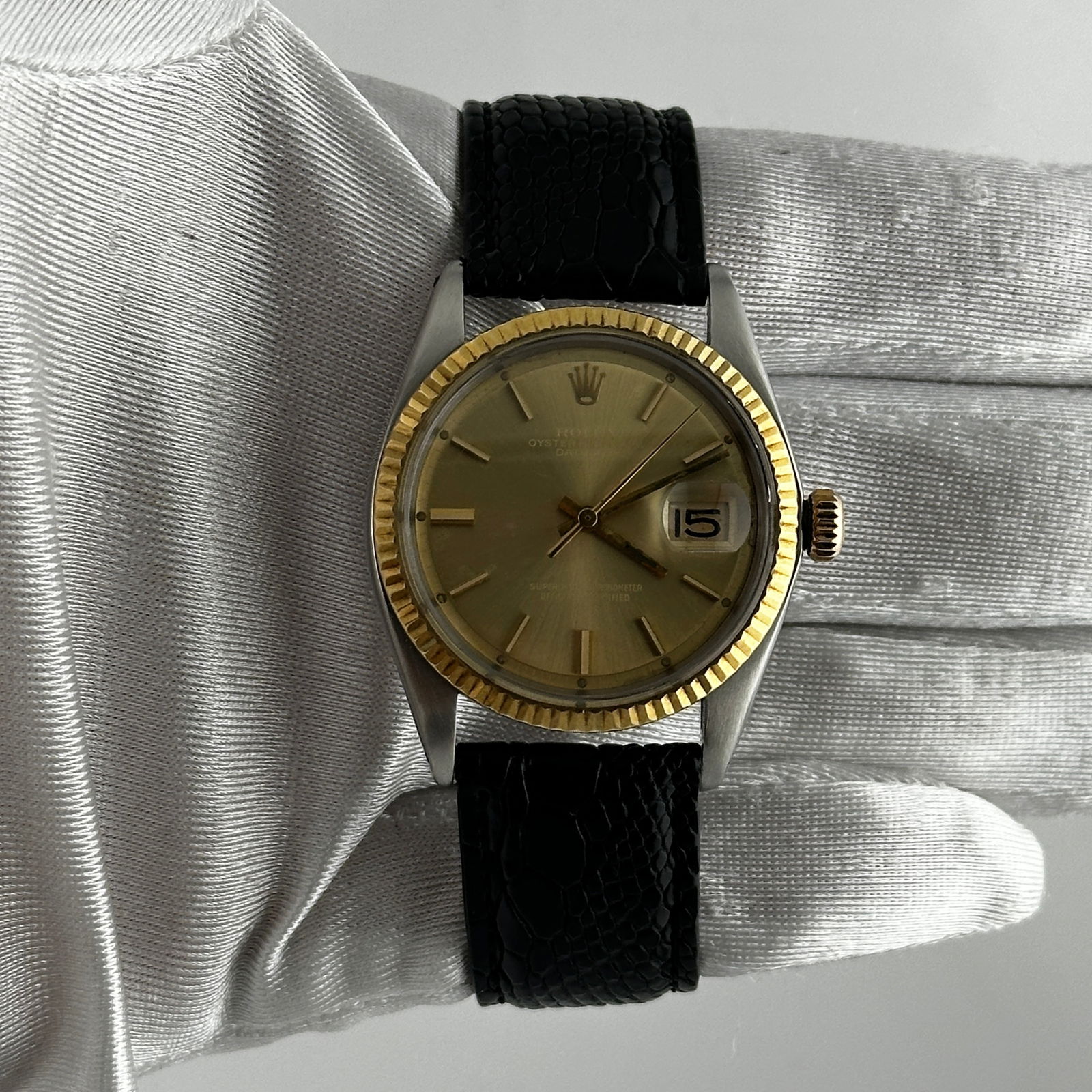 Datejust Ref 1601 Champagne Stick Dial Watch with Aftermarket Leather Strap: Datejust Ref 1601 Champagne Stick Dial Watch with Aftermarket Leather Strap This Rolex Datejust Ref 1601 features a champagne stick dial and a fluted bezel, paired with an aftermarket leather bracelet