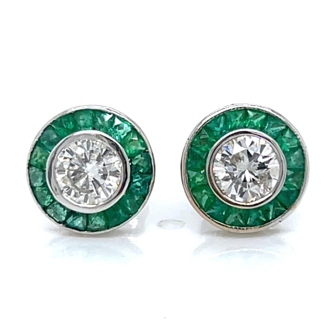 Diamond and Emerald Stud Earrings in 18K White Gold: Diamond and Emerald Stud Earrings in 18K White Gold These stud earrings are crafted from 18K white gold and feature two diamonds with a combined weight of 0.77 carats, graded H-I color and SI1-SI2 cla
