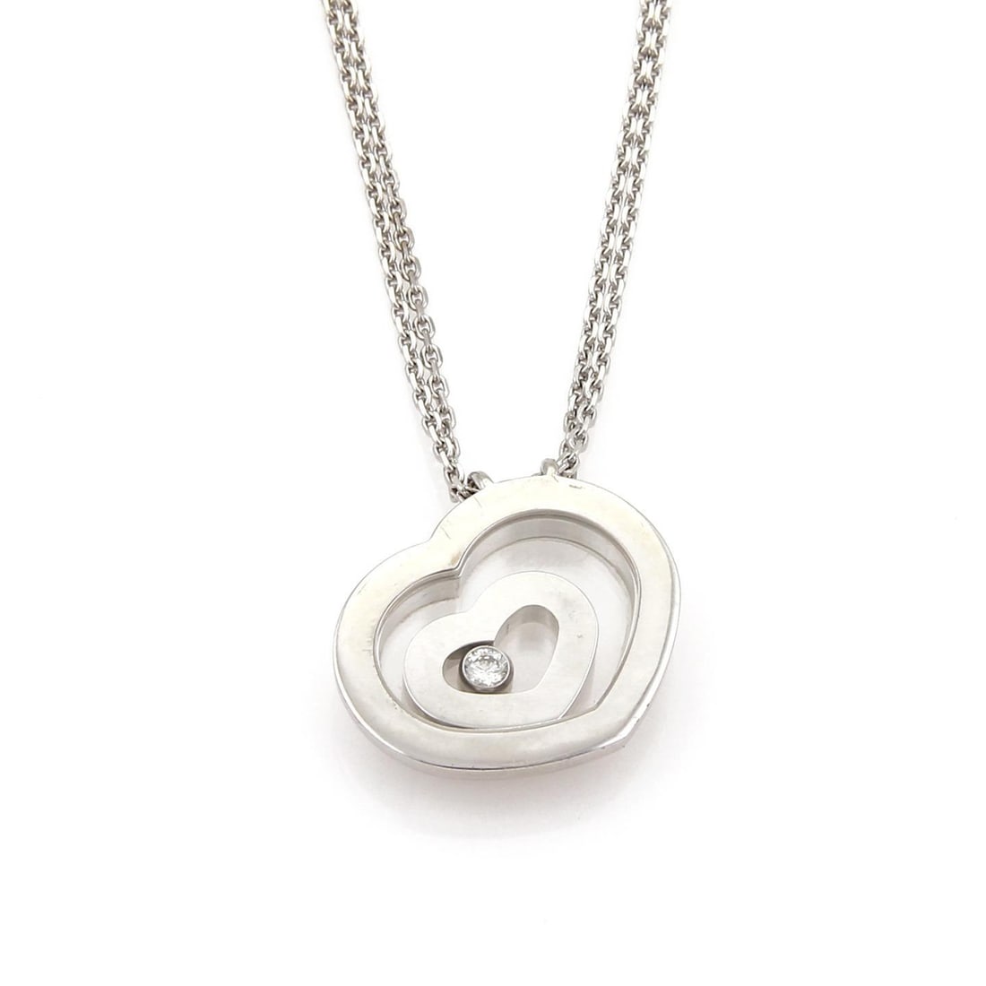 Chopard Happy Spirit 18k White Gold Necklace with Floating Diamond Pendant: Chopard Happy Spirit 18k White Gold Necklace with Floating Diamond Pendant This exquisite Chopard Happy Spirit Necklace features a stunning double heart pendant crafted from 18k white gold. The pendan
